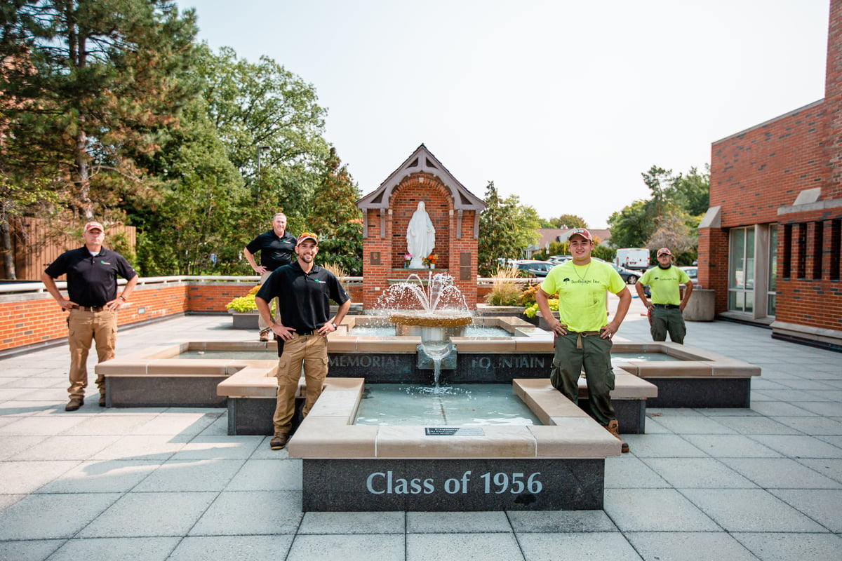 turfscape employees standing near fountain