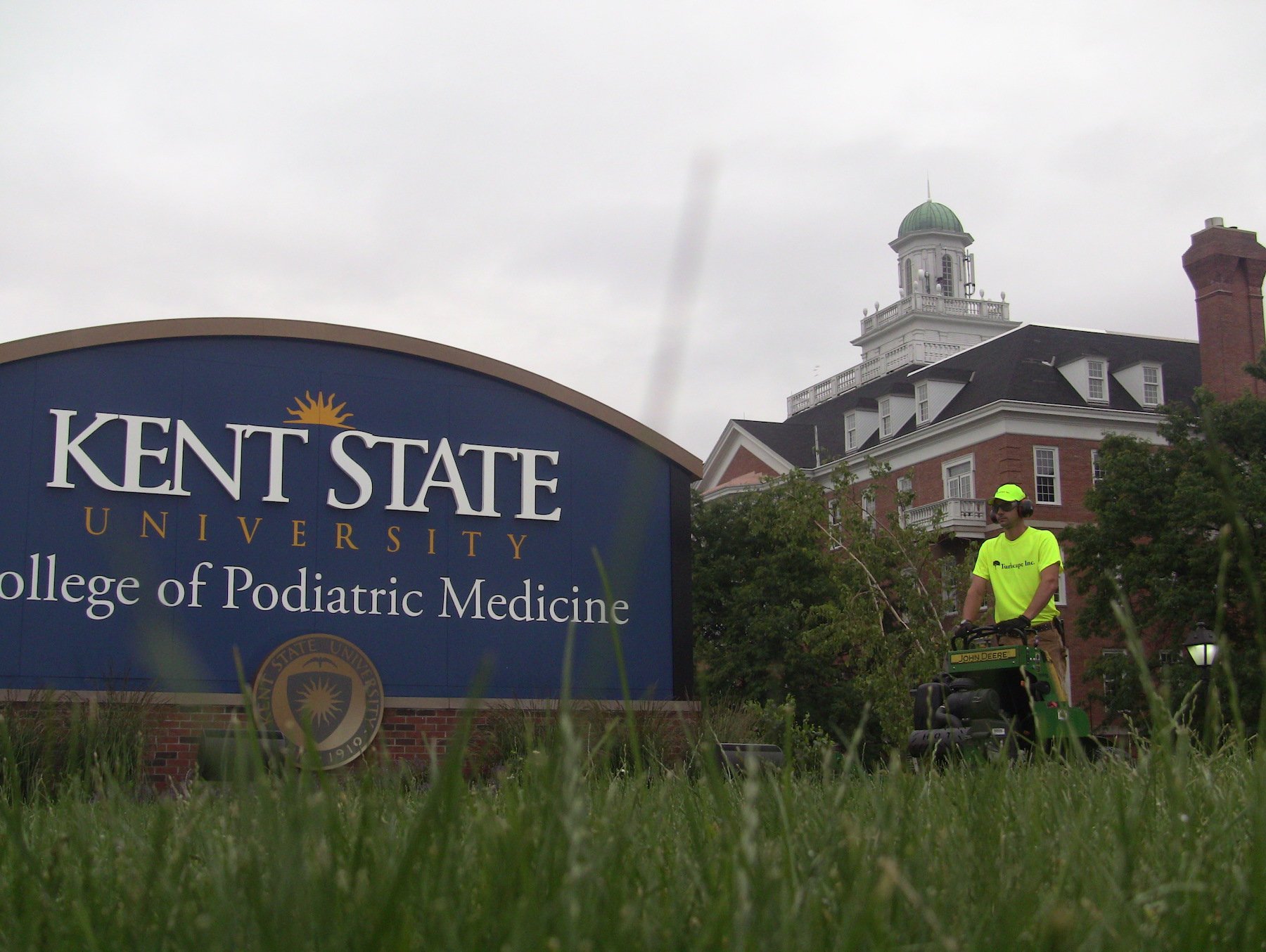 Landscape crew mowing on college campus