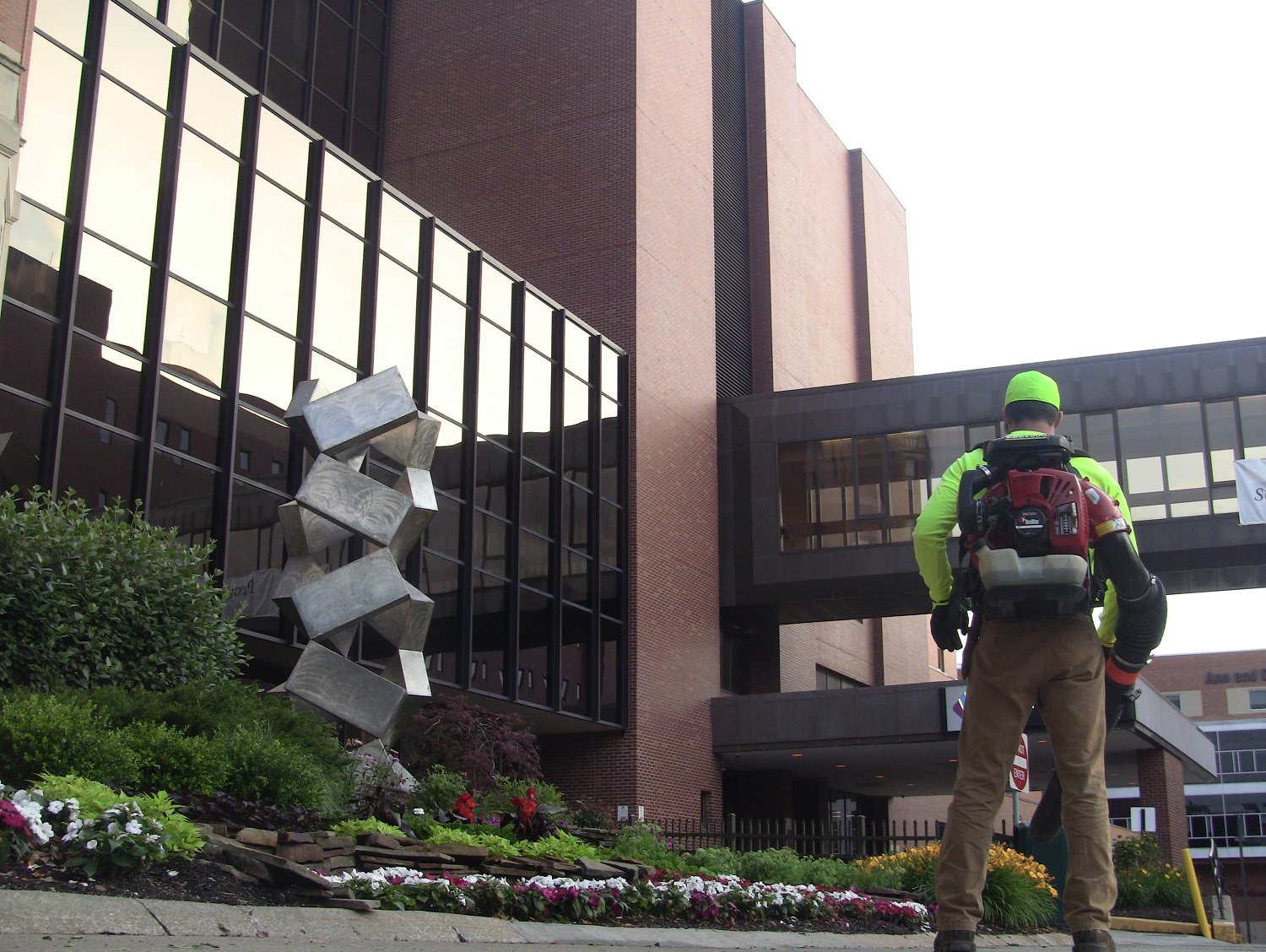 Lawn care technician cleaning up at a hospital