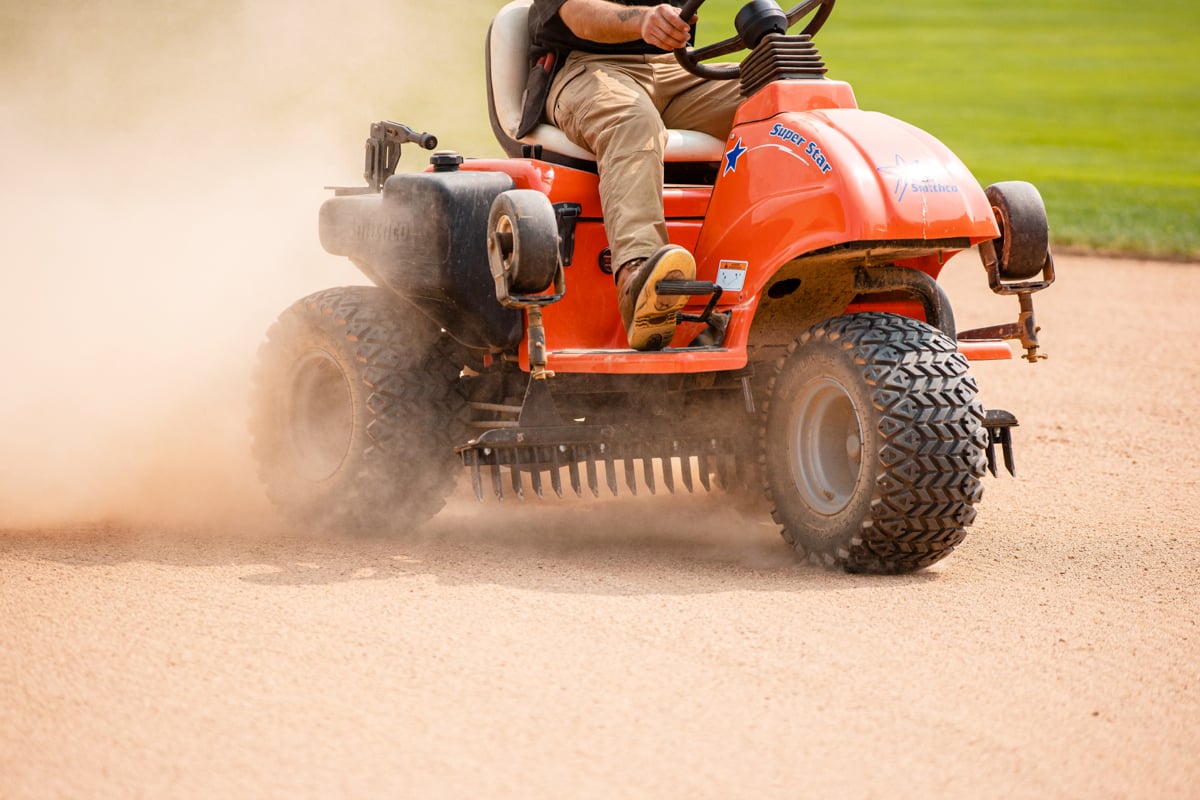 commercial landscaping crew maintains baseball field