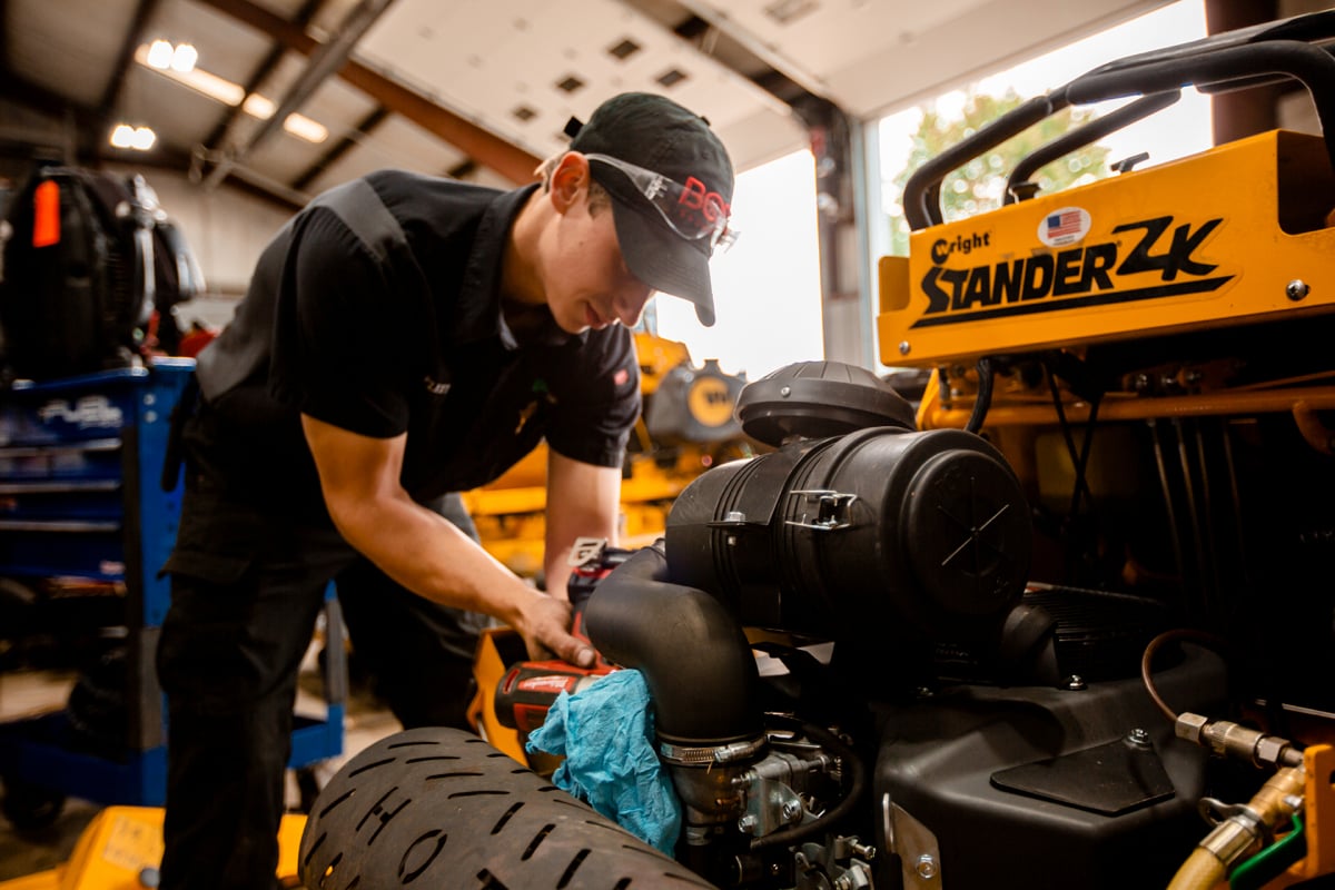 Commercial Landscaping Mechanic working on equipment