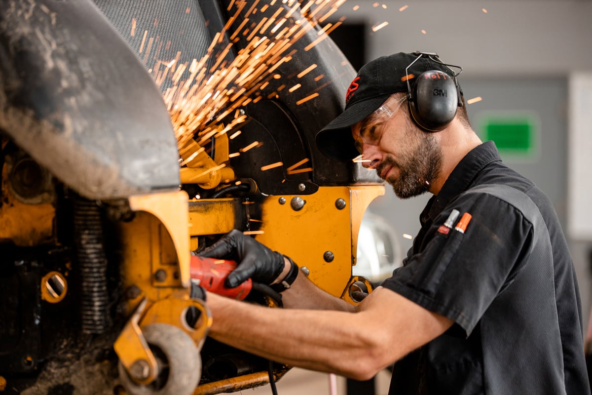 Mechanic working on commercial landscaping equipment