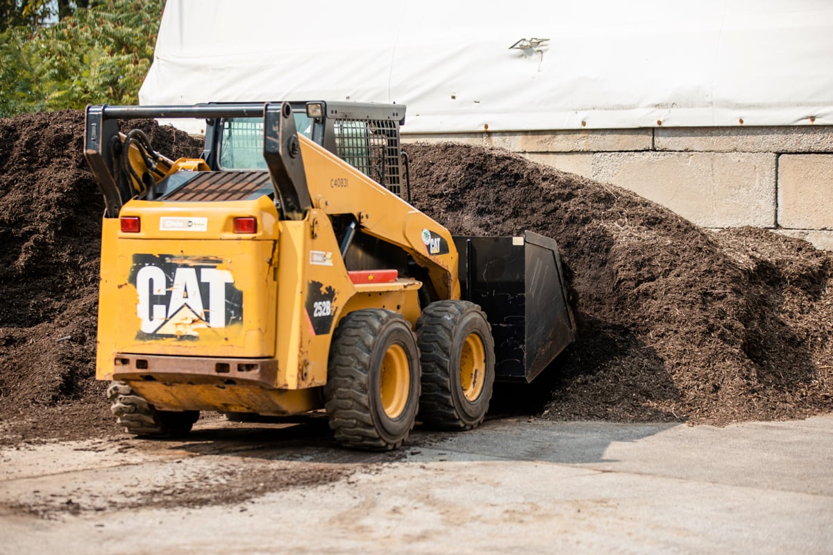 Commercial Landscaping Skid Steer loads up mulch