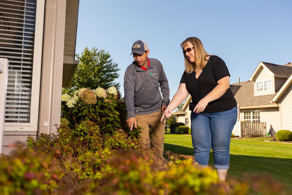 account manager and property manager inspect plantings