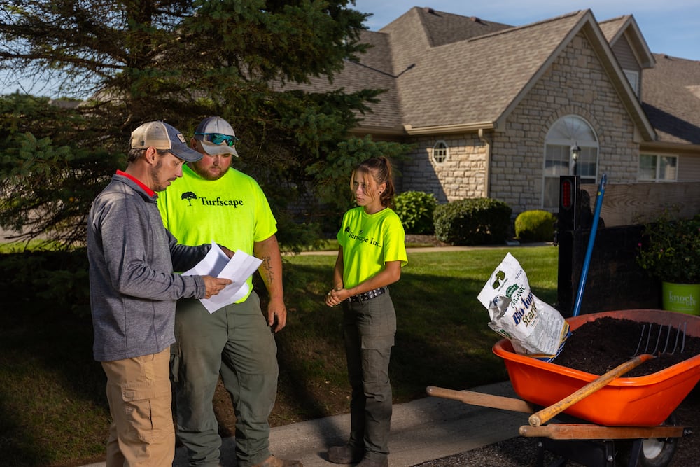 landscape installation crew meets with project manager