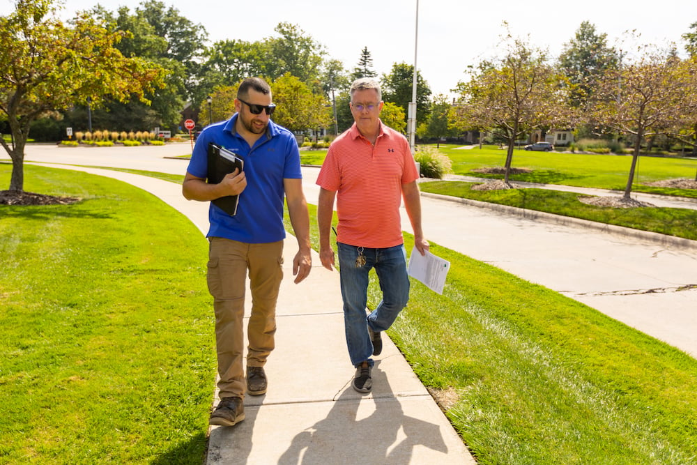 Account manager and customer walking