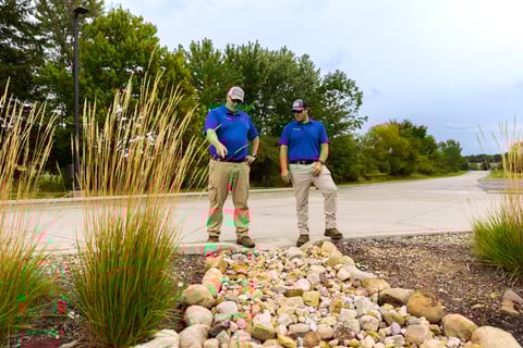 Account managers inspecting dry creek drainage area