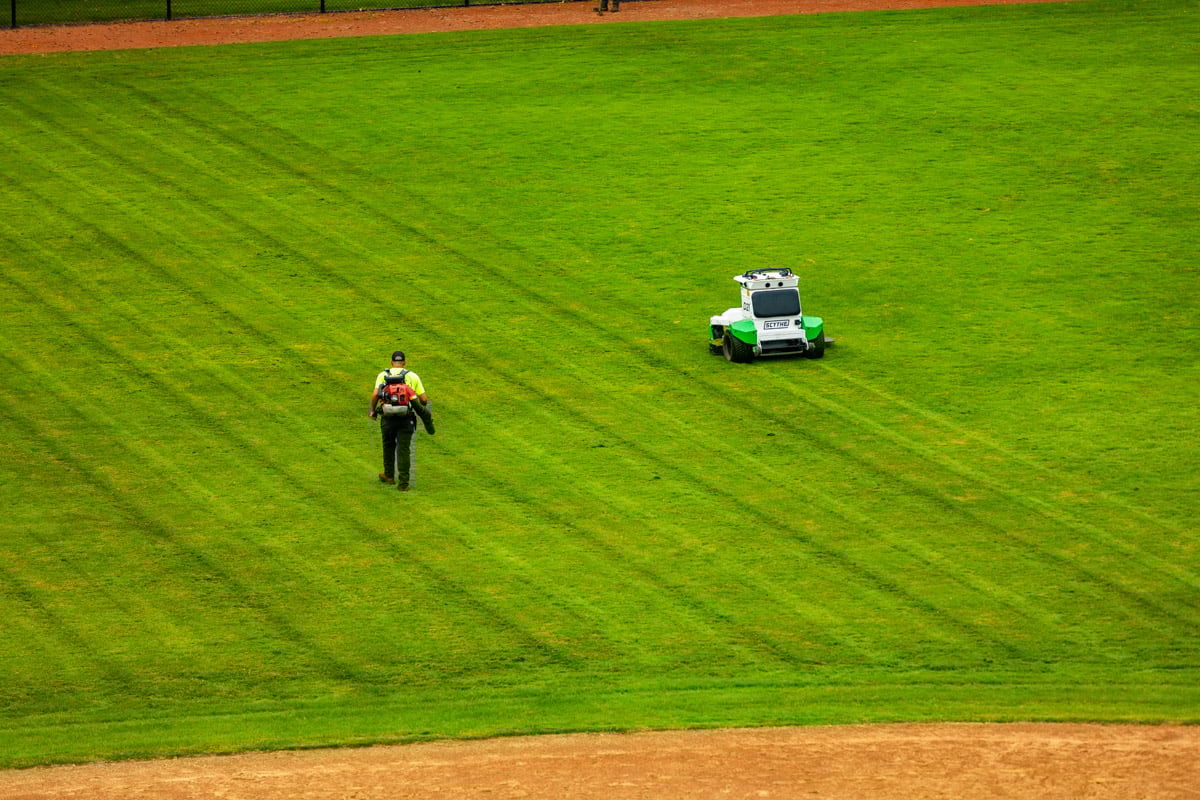 Autonomous commercial robotic mower university athletic field crew blowing 1
