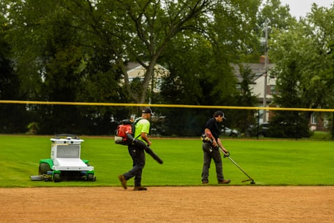 Autonomous commercial robotic mower university crew mowing and blowing atheltic field 1