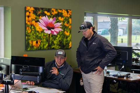 Coommercial landscaping account managers looking at computer