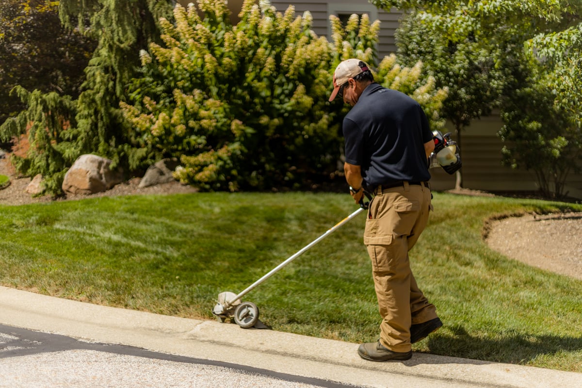 landscape maintenance team edges lawn