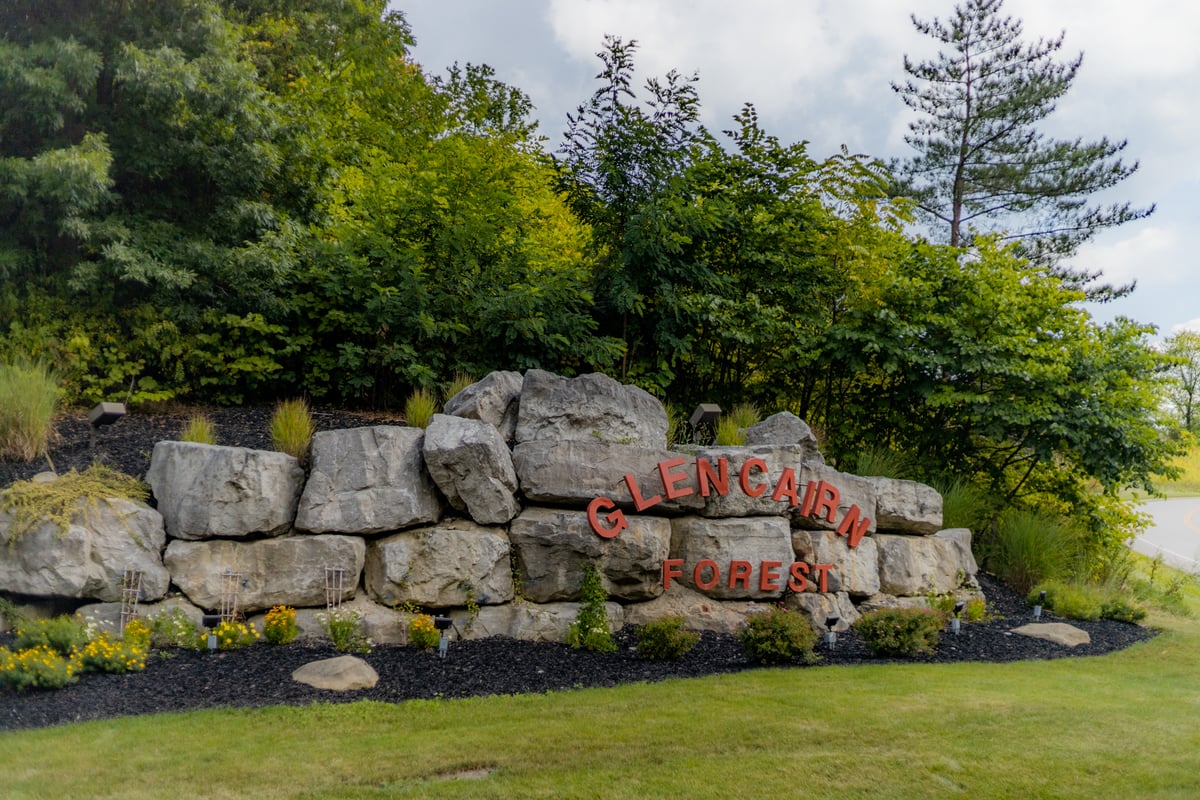 retaining wall at entrance to property with plantings