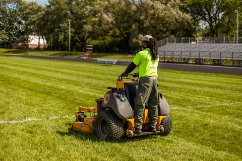Mowing field with bleachers