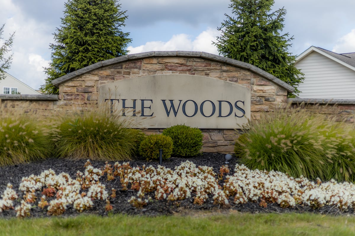 sign with neatly planted grasses shrubs and flowers