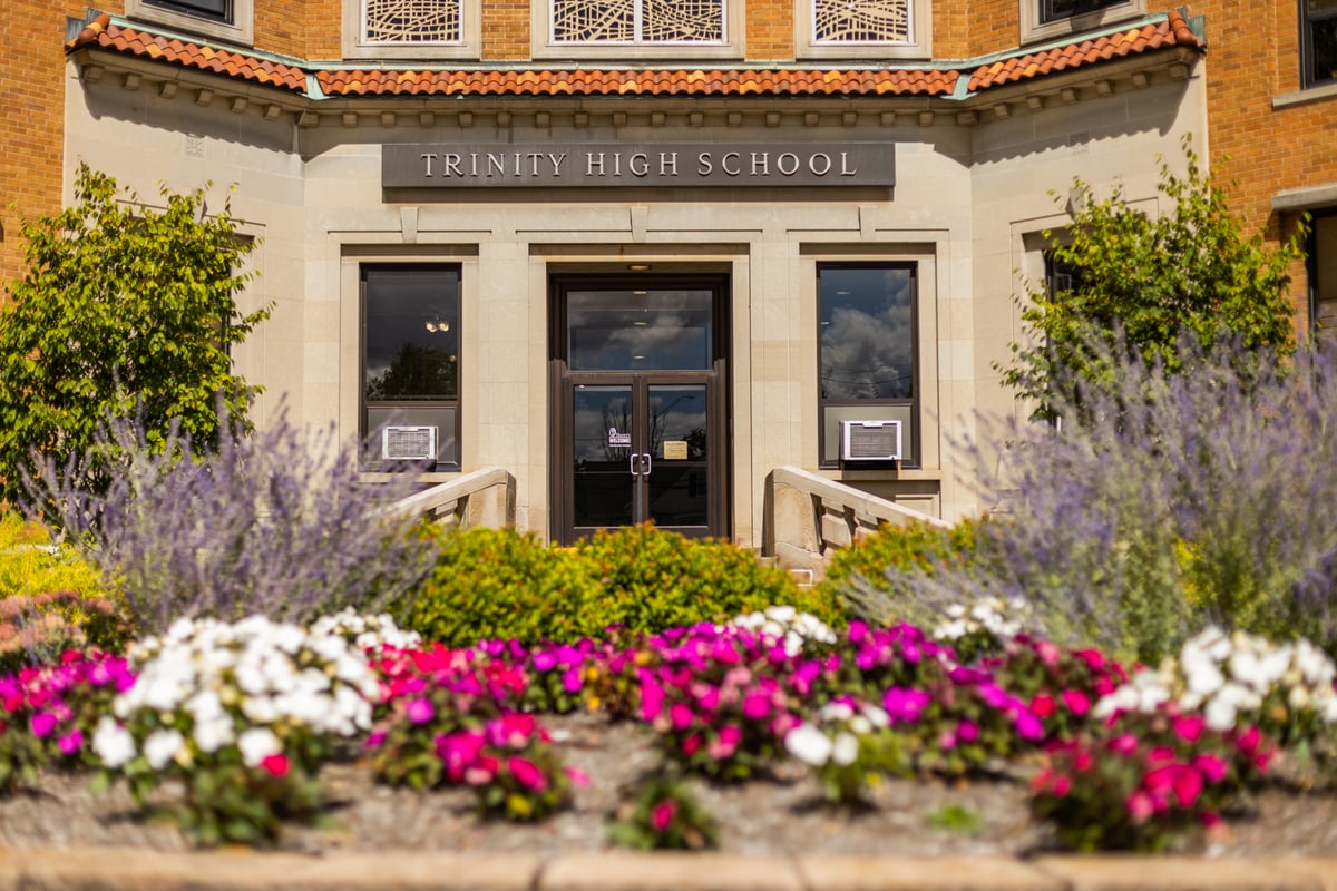 flowers in landscape bed at entrance to school