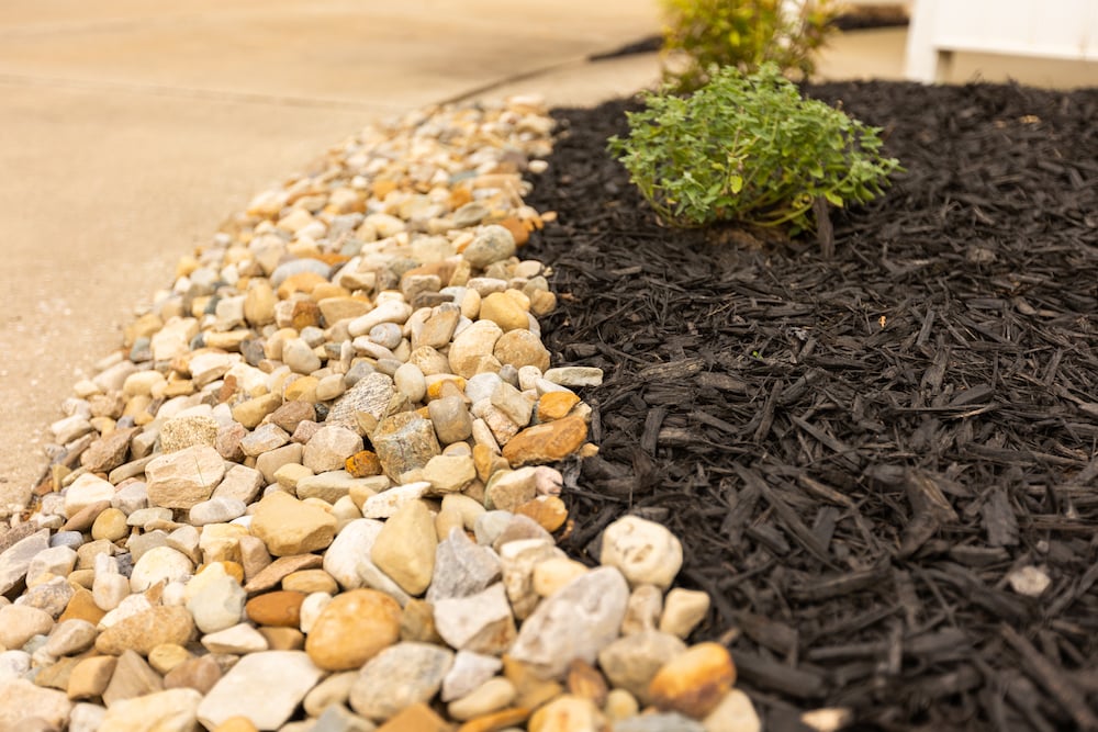 stone lining mulched landscape bed