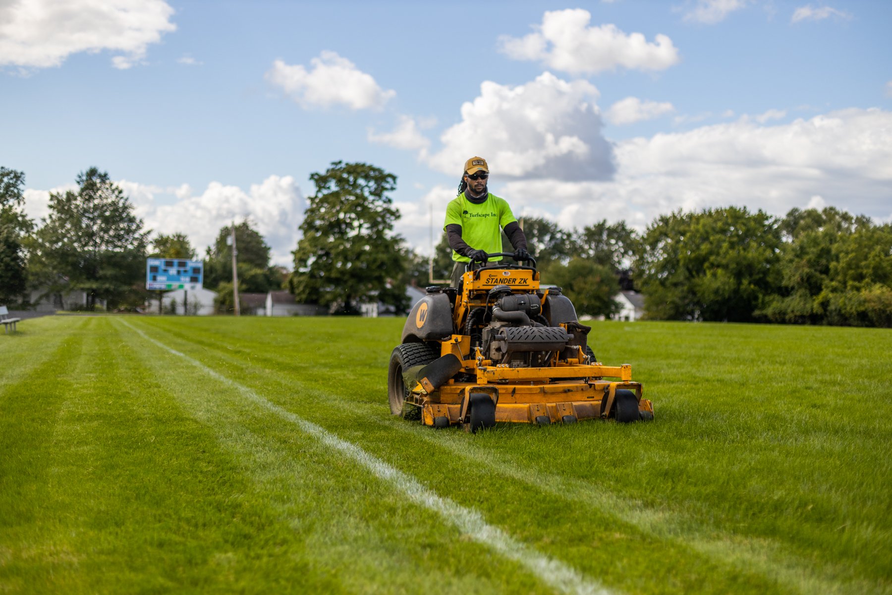 landscape maintenance team mowing lawn