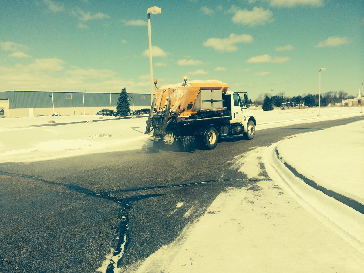 salt truck spreads salt on road