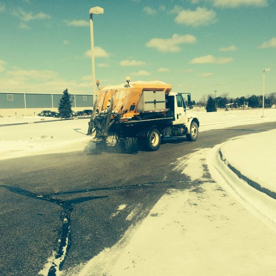 turfscape truck lays salt on roadway