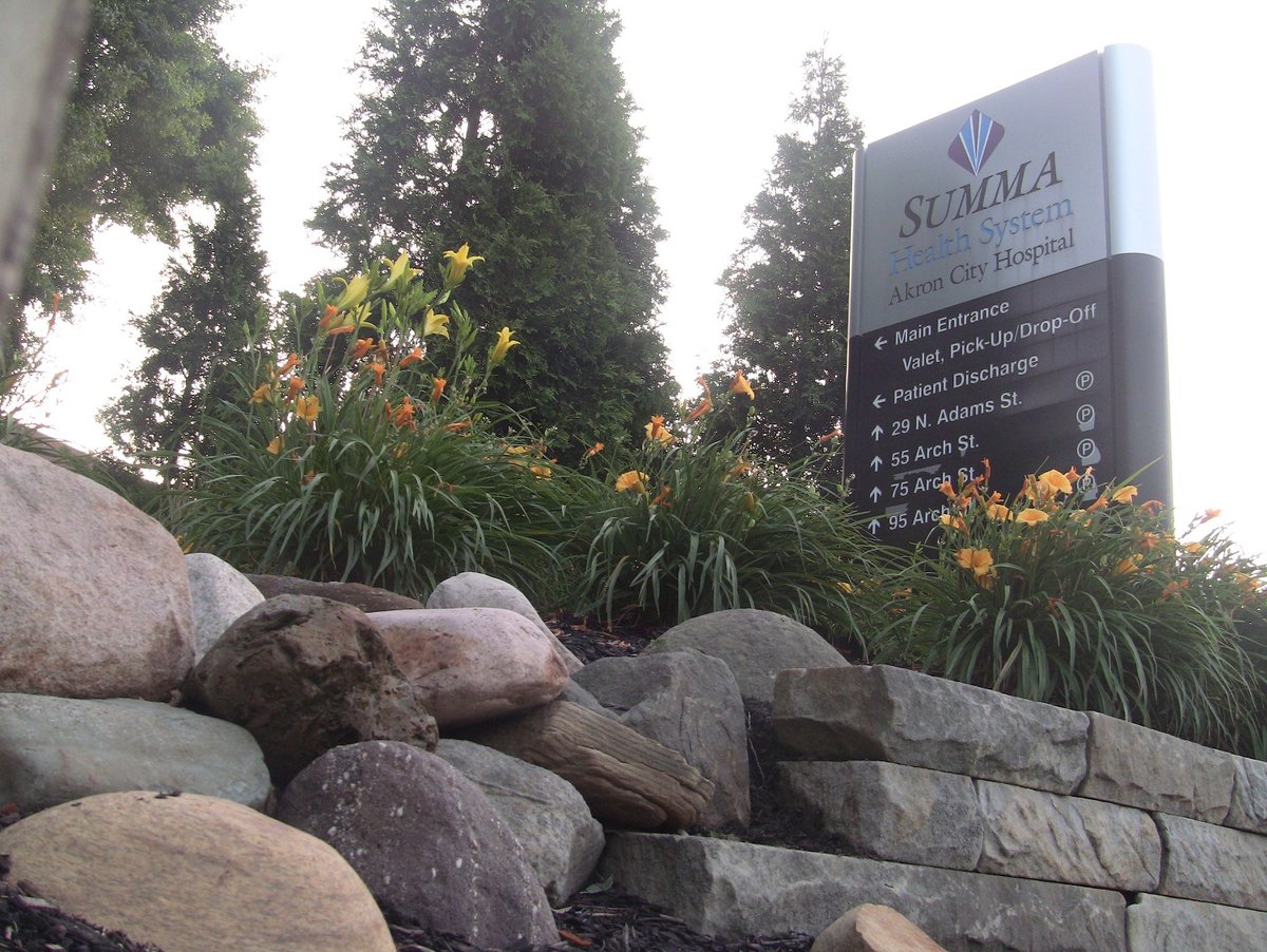 plantings and boulders near sign