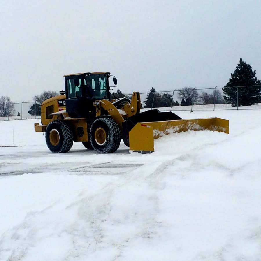 front loader pushes snow